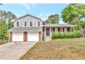 Two-story home featuring a well-manicured front yard, stone accents, and a two-car garage at 8989 Teal Ln, Jonesboro, GA 30236