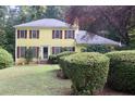 Lovely home with well-maintained landscaping featuring mature shrubbery at 150 Ashley Dr, Fayetteville, GA 30214