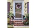 Charming front entrance with a decorative wreath, a storm door, and decorative features at 150 Ashley Dr, Fayetteville, GA 30214