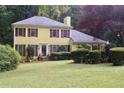 Beautiful yellow home with manicured lawn and mature shrubbery at 150 Ashley Dr, Fayetteville, GA 30214
