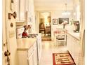 Bright kitchen featuring white cabinets, modern appliances, and an adjoining dining area at 150 Ashley Dr, Fayetteville, GA 30214