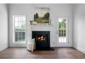 Bright living room featuring a fireplace and an adjacent door leading to the outdoors at 3047 Standing Rock Ct, Lithia Springs, GA 30122