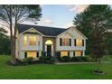 Inviting two-story home with well-manicured lawn and stylish exterior lighting at 4076 Whistler Dr, Douglasville, GA 30135