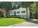 Traditional home featuring a well-kept lawn and a convenient driveway at 4076 Whistler Dr, Douglasville, GA 30135