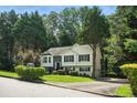 Beautiful home with mature trees, lush lawn, and a paved driveway at 4076 Whistler Dr, Douglasville, GA 30135