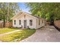 Stylish home boasts a spacious driveway, manicured lawn, and white facade at 2294 Hill St, Atlanta, GA 30318