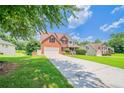 Well-manicured front yard with a spacious driveway leading up to a lovely brick two-story home at 3961 S River Ln, Ellenwood, GA 30294
