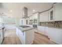 Modern kitchen featuring white cabinetry, granite countertops, stainless steel appliances and large center island at 3961 S River Ln, Ellenwood, GA 30294
