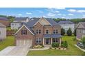 Beautiful two-story brick home featuring a two-car garage, landscaped front yard, and classic architectural details at 2740 Longacre Park Way, Lawrenceville, GA 30044