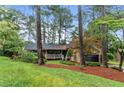 Beautiful single-Gathering home with a welcoming front porch and mature trees at 490 Hunters Glen Ct, Lawrenceville, GA 30044