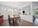 Elegant dining room with modern chandelier and open access to living area at 207 Harmony Lake Dr, Canton, GA 30115