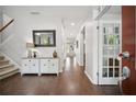 Bright foyer featuring hardwood floors, staircase, and stylish decor at 207 Harmony Lake Dr, Canton, GA 30115