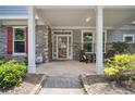 Inviting covered front porch with stone accents and space for seating at 207 Harmony Lake Dr, Canton, GA 30115