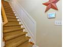 Carpeted stairway with wooden handrail, and an electronic home security system at 2107 Se Gorman Se Grv # 132, Atlanta, GA 30316