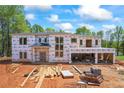 New construction home showing exterior framing, windows, and covered porch under blue skies at 4238 Hamilton Mill Rd, Buford, GA 30519