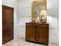 Inviting entryway featuring a wooden cabinet with paneled walls and a gold framed mirror at 1 Brookhaven Ne Dr # 205, Atlanta, GA 30319