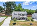 Aerial view of two-story home boasts beautiful lawn and a brick and siding exterior at 1620 Brook Ivy Dr, Lawrenceville, GA 30044