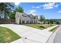 Stately home features a brick and siding exterior, long driveway, and beautifully landscaped front yard at 1620 Brook Ivy Dr, Lawrenceville, GA 30044