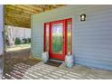 A charming red front door with sidelights is visible, complete with decorative porch decor at 8531 Lake Dr, Snellville, GA 30039