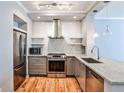 Modern kitchen featuring stainless steel appliances, subway tile, and hardwood floors at 1126 Village Ct, Atlanta, GA 30316