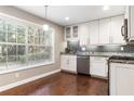 Bright kitchen with stainless steel appliances, granite counters, and a large window overlooking greenery at 6980 Roswell Rd # N5, Atlanta, GA 30328