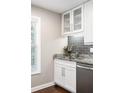 Well-appointed kitchen area featuring gray backsplash, granite counters, stainless steel appliances, and ample storage at 6980 Roswell Rd # N5, Atlanta, GA 30328