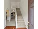 Bright entryway featuring hardwood floors, staircase, and views to adjacent living spaces at 802 Cormac Dr, Riverdale, GA 30296