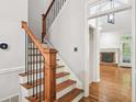 Staircase with wood treads, white risers, and black iron spindles lead to the upper level at 171 Riverview Trl, Roswell, GA 30075