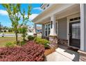 Inviting front porch with stone accents and a view of the landscaped yard at 427 Bluffs View Ln, Canton, GA 30114