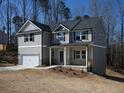 Charming two-story home with a covered porch, attached garage, and well-manicured lawn on a sunny day at 250 Shawnee Trl, Dallas, GA 30157