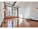 Spacious living room featuring exposed brick, hardwood floors, and large windows at 1261 Caroline St # 211, Atlanta, GA 30307