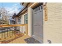 Close-up of a stylish front door with a wooden porch, featuring a home address plaque for easy identification at 2191 Essex Sw Ave, Atlanta, GA 30311
