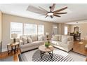 Spacious living room showcasing hardwood floors, neutral sofas, and ample natural light from the surrounding windows at 2191 Essex Sw Ave, Atlanta, GA 30311