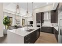 Bright modern kitchen with stainless steel appliances, island with sink, and open floor plan at 40 12Th St # 1004, Atlanta, GA 30309