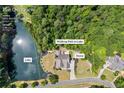 Aerial view of the home and surrounding property, highlighting its location on the lake and lush greenery at 1005 Renfroe Lake Dr, Auburn, GA 30011