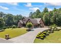 Stunning home featuring a long driveway, lush lawn, beautiful landscaping and an attached garage at 1005 Renfroe Lake Dr, Auburn, GA 30011