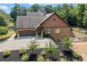 View of the house showing the beautiful landscaping and long driveway at 1005 Renfroe Lake Dr, Auburn, GA 30011