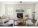Cozy living room with a fireplace, hardwood floors, neutral decor, and plenty of natural light at 2813 White Oak Ln, Decatur, GA 30032