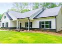 Beautiful one-story home with a white exterior, black shutters and large front yard at 5525 Belle Meade Dr, Villa Rica, GA 30180