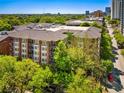 Beautiful red brick apartment building with manicured trees and balconies at 850 Piedmont Ne Ave # 1206, Atlanta, GA 30308