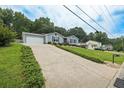 Long driveway leading to a one-story home with an attached garage, providing ample parking space at 2711 Bluffton Rd, Buford, GA 30519
