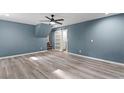 Spacious living room with a ceiling fan and sliding barn door to the bathroom at 4339 Rushmore Pl, Forest Park, GA 30297