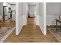 Hallway with wood floors leads to an open kitchen and other living spaces at 1444 Arden Sw Dr, Marietta, GA 30008