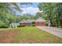 A well-maintained single-Gathering home with a lush green lawn and tree-lined surroundings at 1721 Druids Se Xing, Conyers, GA 30013