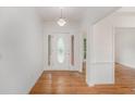 Bright entry with hardwood floors and a decorative front door featuring sidelights at 1721 Druids Se Xing, Conyers, GA 30013