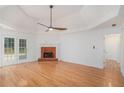 Spacious living area with hardwood floors, a brick fireplace, and access to the patio at 1721 Druids Se Xing, Conyers, GA 30013
