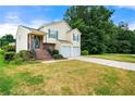 Well-kept home with a two-car garage, brick-accented entry, and a green lawn at 5718 Hidden Brook Cir, Atlanta, GA 30349