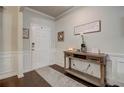Bright entryway featuring hardwood floors, console table, and decorative wall molding at 7246 Gladstone Cir, Lithonia, GA 30038