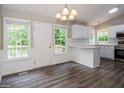 Eat-in kitchen with hardwood floors and white cabinets at 75 Willow Bend Nw Dr, Cartersville, GA 30121