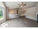 Open-concept living area with hardwood floors, a ceiling fan, and a fireplace at 75 Willow Bend Nw Dr, Cartersville, GA 30121